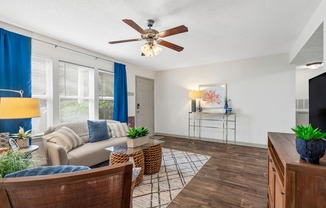 Living room with a couch and a ceiling fan at Lofts of Wilmington, Wilmington, NC