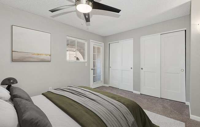 Model Bedroom with Carpet and Double Closets at Stillwater Apartments in Glendale, AZ.