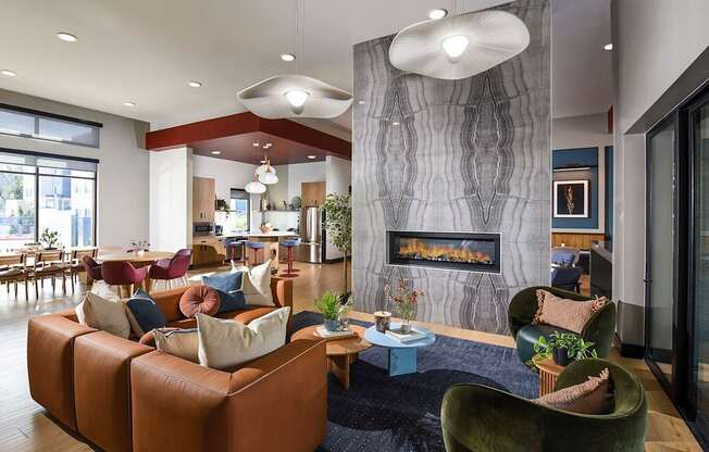 A modern living room with a fireplace and a variety of seating options.