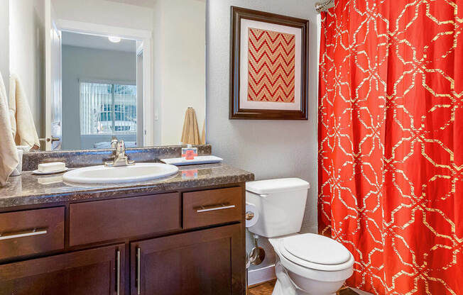 a bathroom with a red shower curtain at Mullan Reserve Apartments, Missoula, MT 59808
