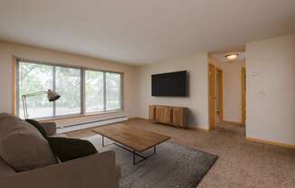 a living room with a couch and a coffee table. Fargo, ND Birchwood 2 Apartments