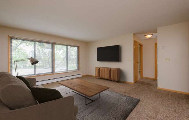 a living room with a couch and a coffee table. Fargo, ND Birchwood 2 Apartments
