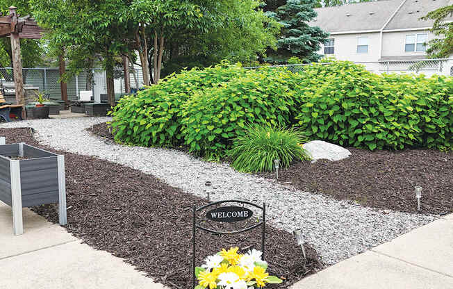 A garden with a sign that says