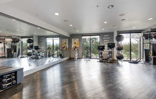 A gym with a variety of equipment and a sign that says