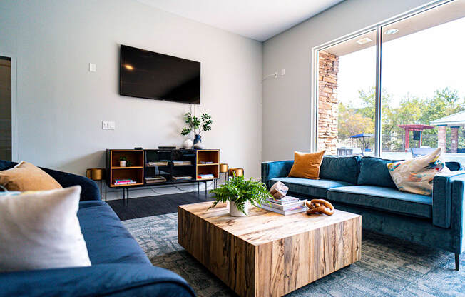 a living room with blue couches and a coffee table