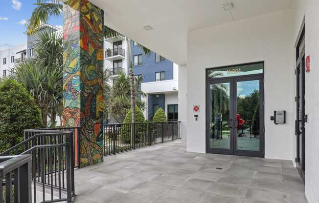 Entrance to our community lobby with pillars with artistic murals at Bay Village 1 in Palmetto Bay, FL