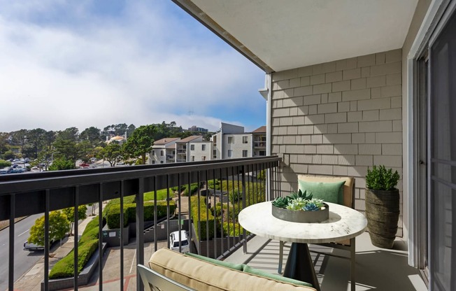 a balcony with a table and chairs and a city view at Delphine on Diamond, San Francisco, California