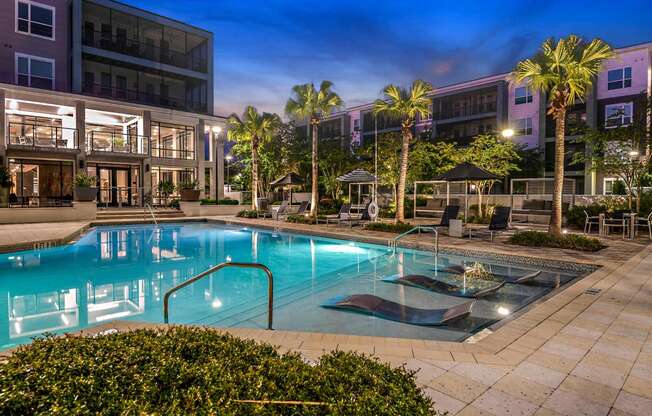 a swimming pool at night at the grove apartments