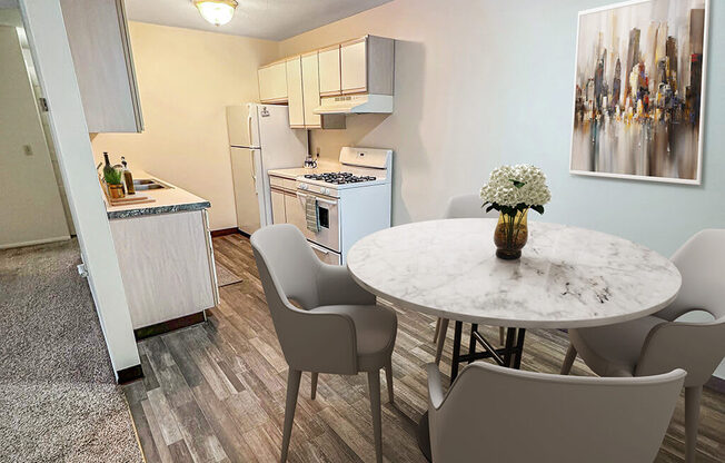 A kitchen with a table and chairs in front of it.