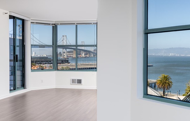 A room with a view of a bridge over the water.