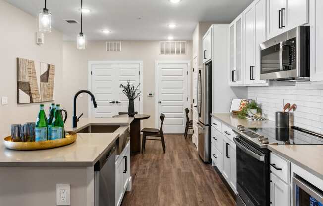 an open kitchen with a large counter top and a sink