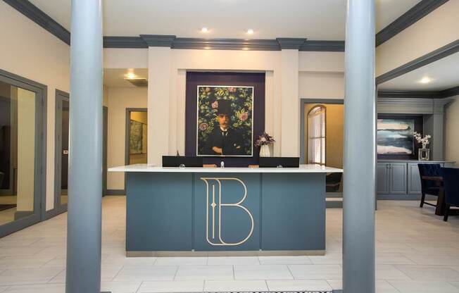 A reception desk with a gold letter B on it.