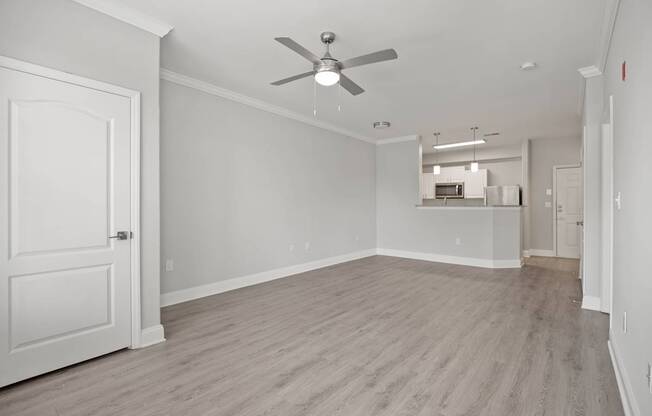 A room with a ceiling fan and light fixture.