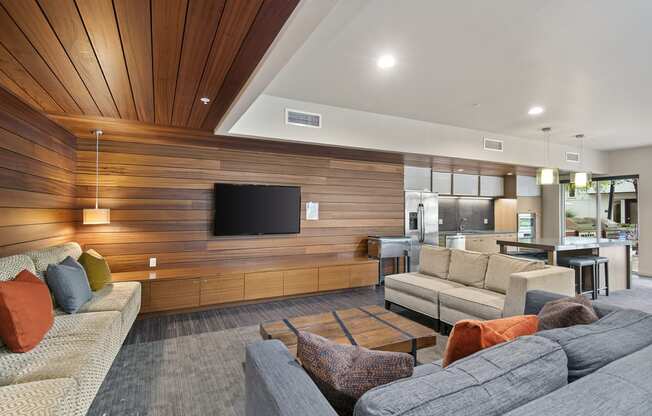 a living room with wood paneling and a tv on the wall