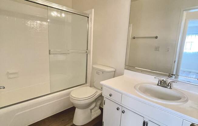 Bathroom with White Cabinets, Hardwood Floors and Bathtub/Shower