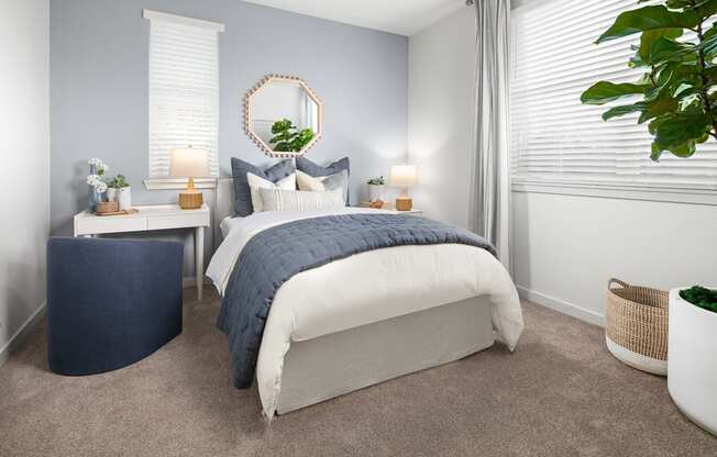 a bedroom with a bed and two windows with white blinds at Solstice at Fiddyment Ranch, California