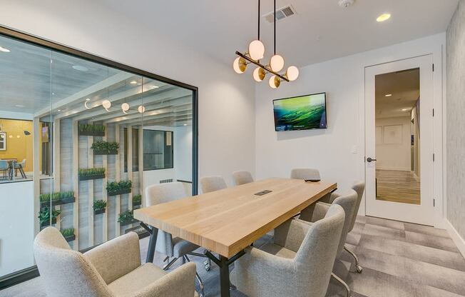 a dining room with a wooden table and chairs