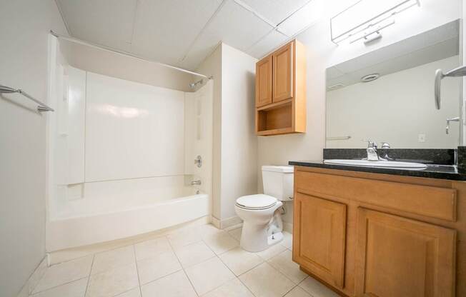 A bathroom with a toilet, sink, and bathtub.