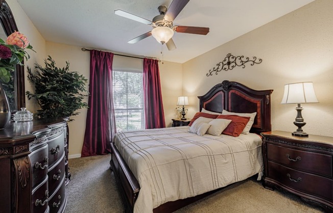 a bedroom with a large bed and a ceiling fan