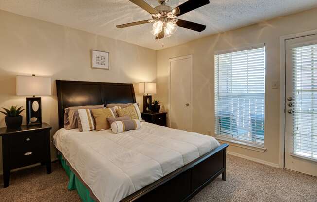 a bedroom with a large bed and a ceiling fan