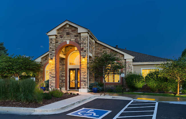 A building with a stone facade and a large arched entrance.