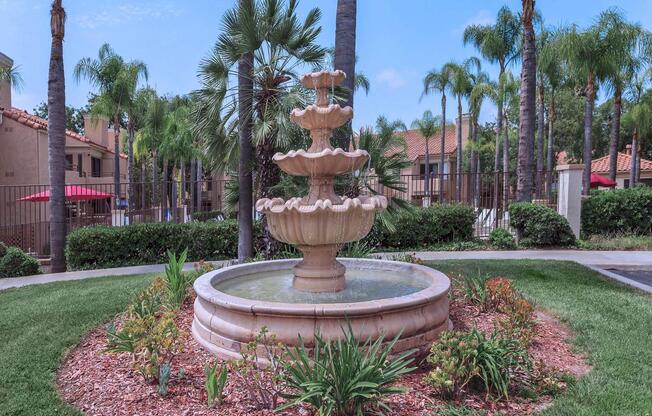 a small clock tower in the middle of a garden