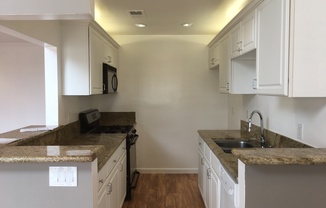 Beautifully Renovated 3 Bed/2 Bath Apartment in Canoga Park with Hardwood Floors, Central Air Conditioning, Stainless Steel Appliances, Private Balcony, and Laundry HookUps