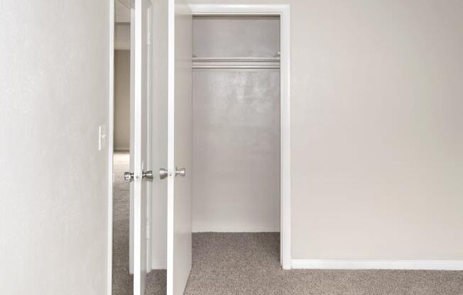 a closet with a hanging bar in a home at Park Apartments