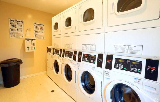 a laundry room with a bunch of washing machines