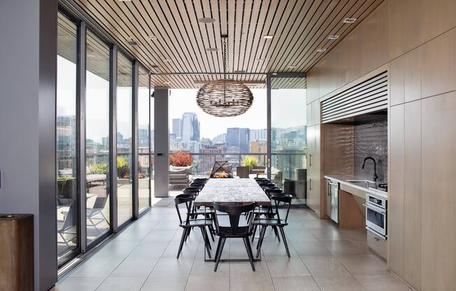 a large dining room with a long table and a city view