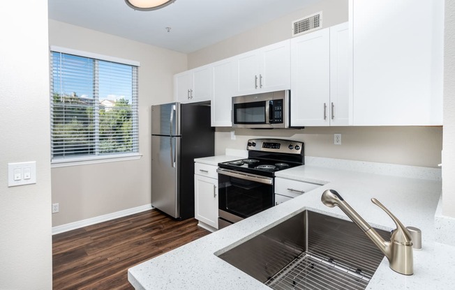 Chino Hills CA Apartments - Missions at Chino Hills - Modern Kitchen with Wood-Style Flooring and a Side Window