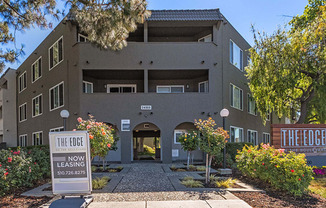 Entry walkway to building with sign at The Edge on the Boulevard, California