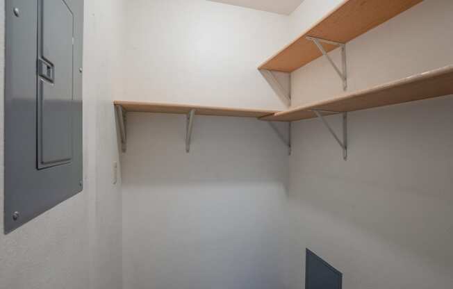 a room with white walls and a shelf on the wall. Fargo, ND Southview Village Apartments