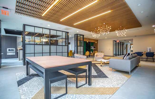A modern dining room with a wooden table and chairs.