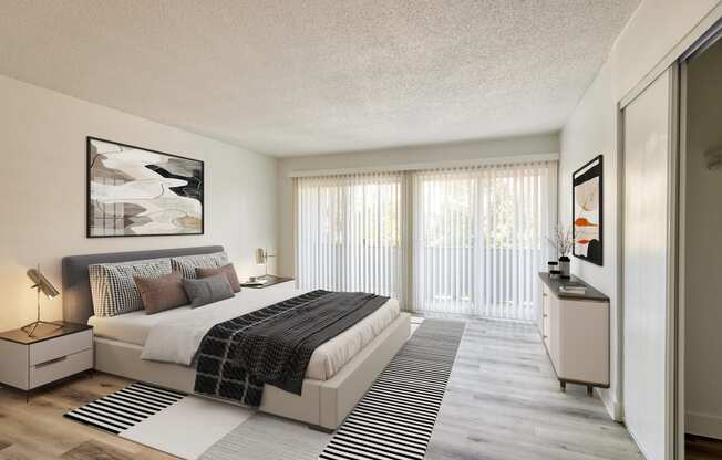 a bedroom with a bed and a large window