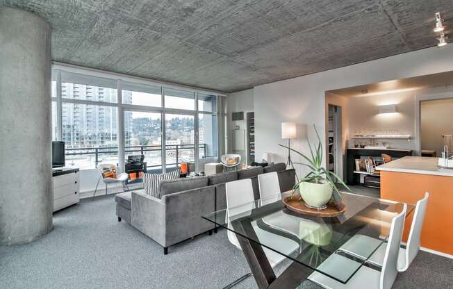 a living room with a glass table and a couch