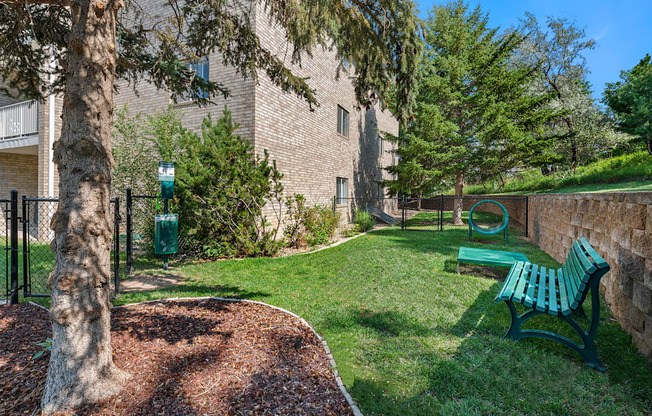 our apartments have a small yard with a bench and a tree