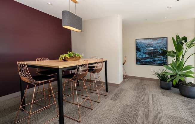 A dining room with a wooden table and chairs.