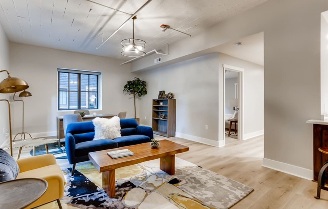 a living room with a blue couch and a coffee table