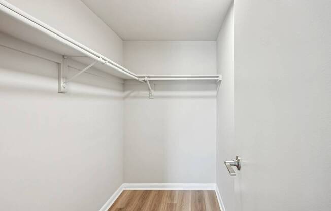 A white room with a wooden floor and a door.