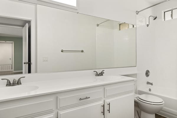 a bathroom with a sink and a toilet and a mirror at NOHO GALLERY Apartments, North Hollywood , 91601