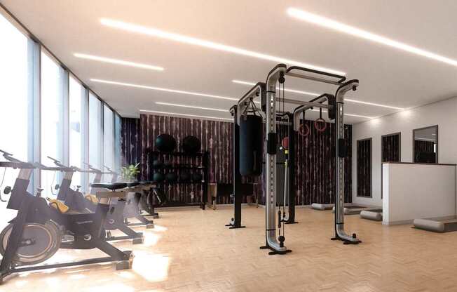 A gym with a row of exercise bikes and a row of weight machines.