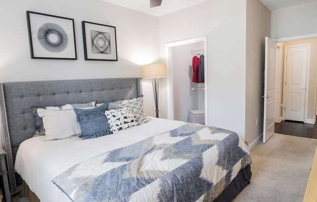 A bedroom with a large bed and a ceiling fan.