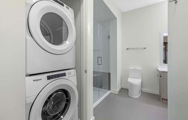 A white Whirlpool washing machine in a laundry room.