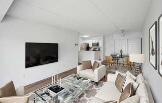 Model living room with view of dining area and kitchen