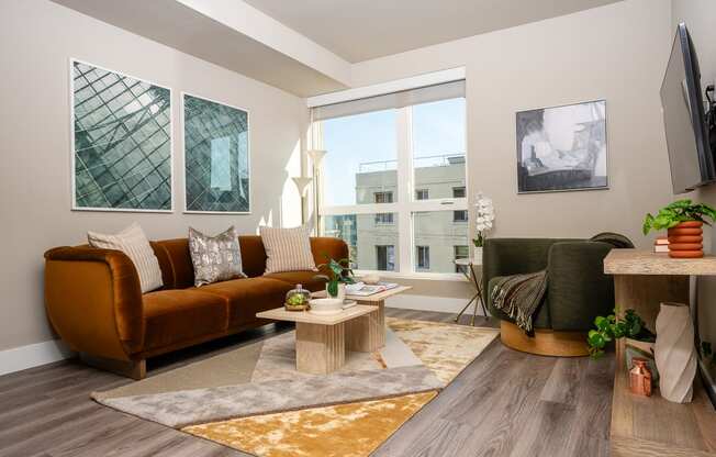 Apartments for Rent in Downtown Los Angeles, CA - The Emerald - Living Room with Floor-to-Ceiling Window, Abstract Coffee Table, and Luxury Plank Flooring