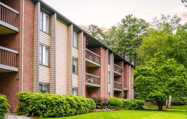Stone run east apartment building exterior with lush landscaping