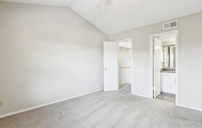 A3 floor plan bedroom with vaulted ceiling and private bathroom entrance at Jefferson Creek Apartments in Irving, TX.