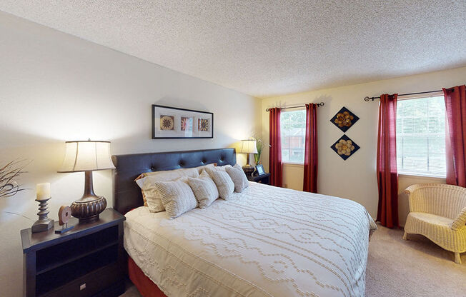 a bedroom with a large bed and a window