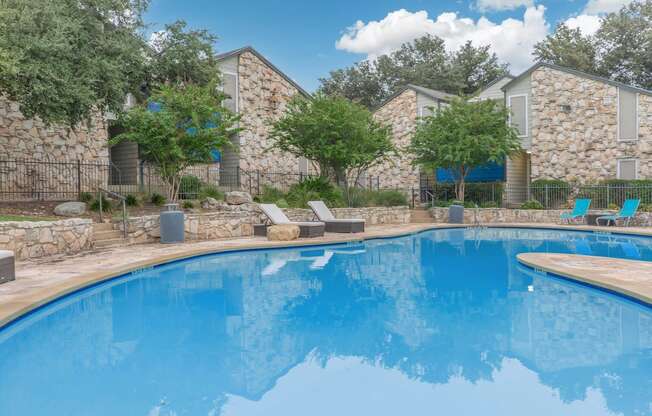 a swimming pool at a resort with a blue pool